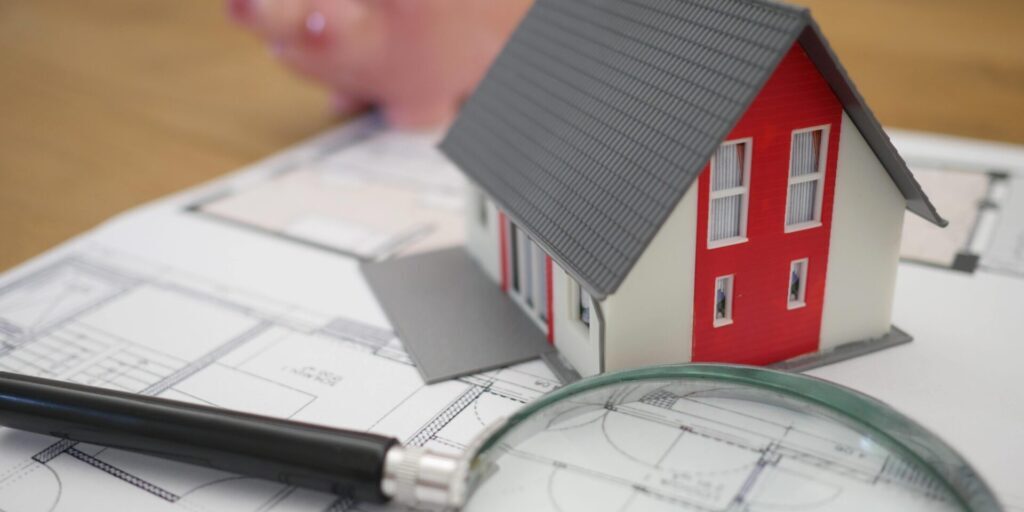 Magnifying Glass with Model of Small House